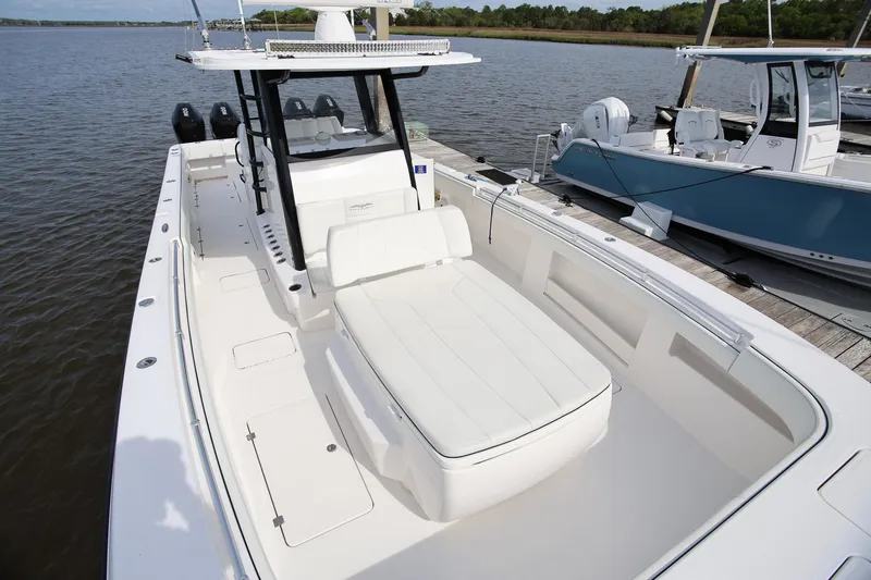 Slide: The Image of 2020 Invincible 35 Catamaran docked, showcasing spacious deck and seating area. - 33