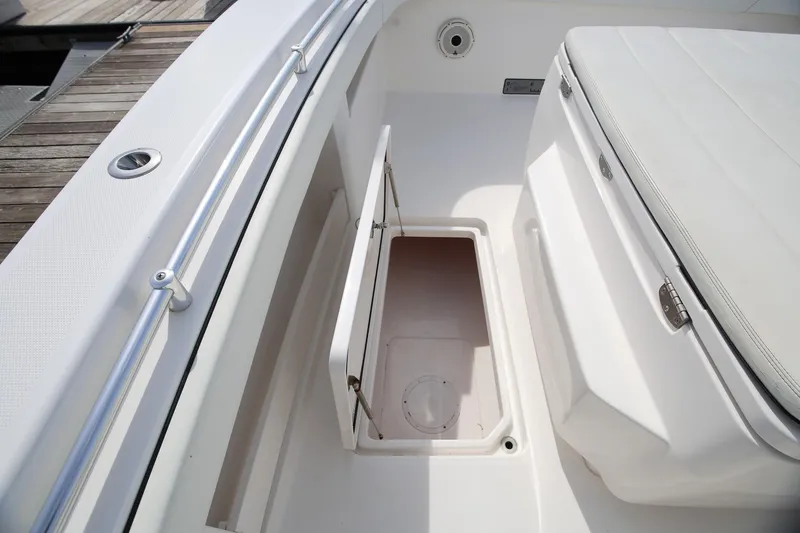 Slide: The Image of 2020 Invincible 35 Catamaran storage compartment with open hatch, showcasing sleek design. - 35