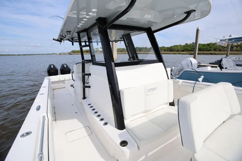 Slide: The Image of 2020 Invincible 35 Catamaran on water, showcasing sleek design and spacious deck. - 36