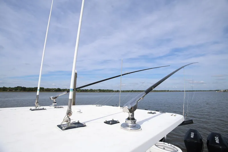 Slide: The Image of 2020 Invincible 35 Catamaran with fishing outriggers on a calm water backdrop. - 37