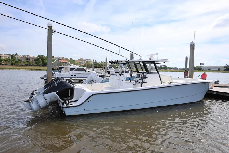 Slide: The Image of 2020 Invincible 35 Catamaran docked by the waterfront, featuring dual outboard engines. - 4