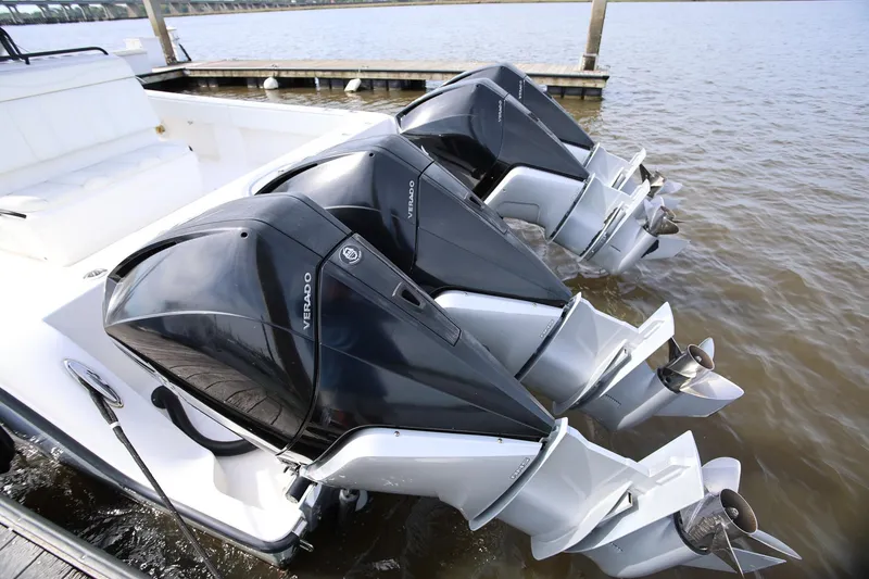 Slide: The Image of 2020 Invincible 35 Catamaran with triple Verado outboard engines docked by the water. - 8