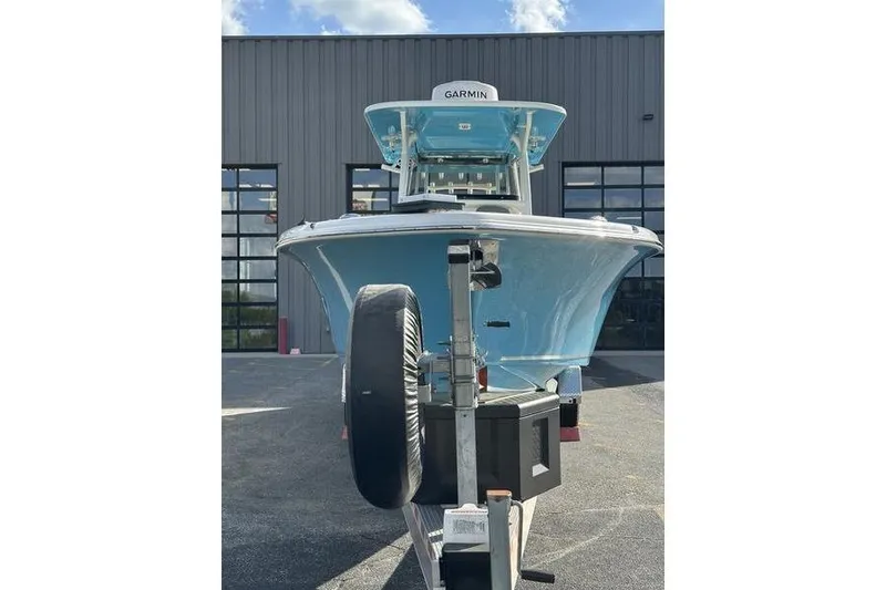 Slide: The Image of 2024 Key West 291 FS boat with blue canopy under a clear sky. - 12