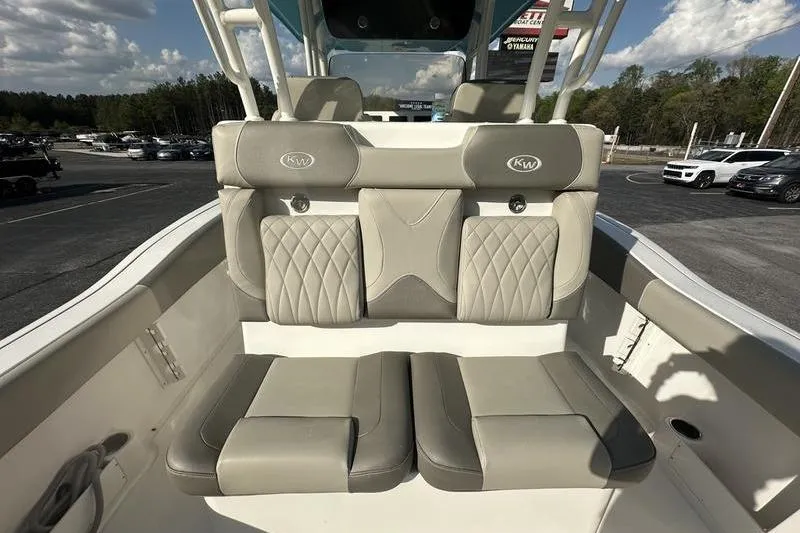Slide: The Image of 2024 Key West 291 FS boat with dual engines and cushioned seating. - 14