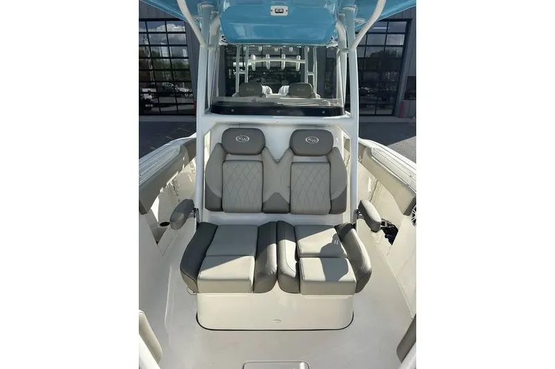 Slide: The Image of 2024 Key West 291 FS boat interior with Garmin equipment, featuring seating and console. - 19