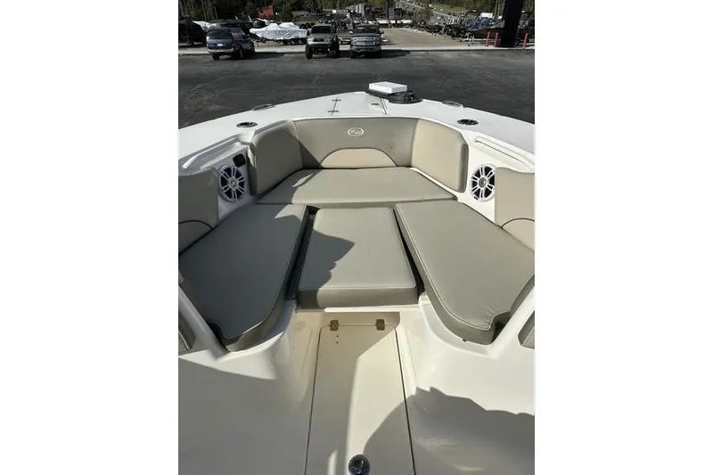 Slide: The Image of 2024 Key West 291 FS boat interior with cushioned seating and speakers. - 2