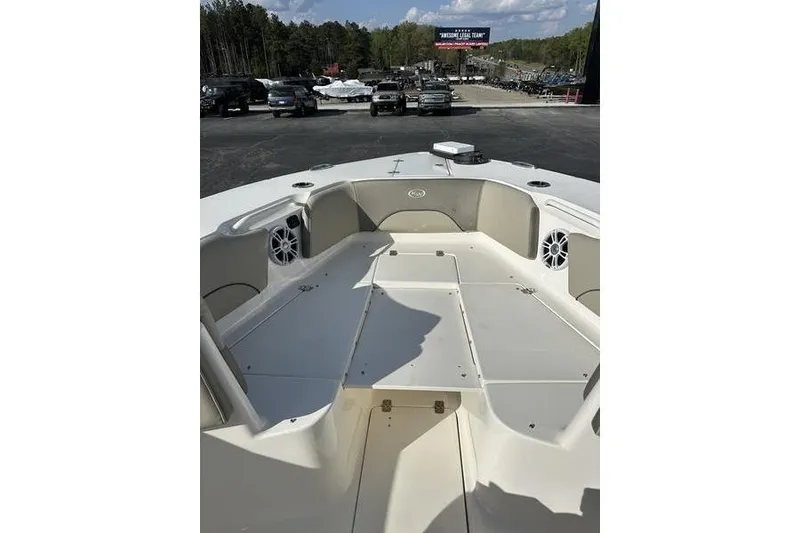 Slide: The Image of 2024 Key West 291 FS boat interior with seating and storage, parked outdoors. - 3