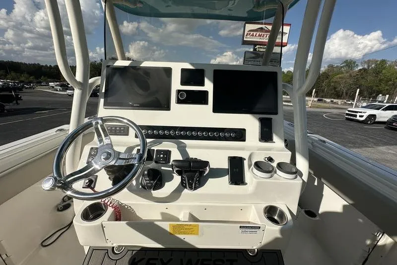 Slide: The Image of 2024 Key West 291 FS boat dashboard with steering wheel and electronic controls. - 5