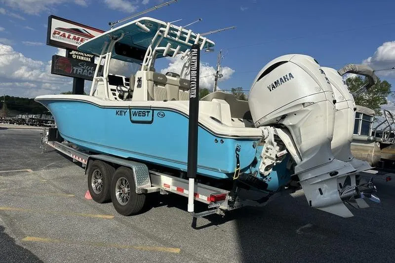 Slide: The Image of 2024 Key West 291 FS boat on trailer with Yamaha engine, parked outdoors. - 6