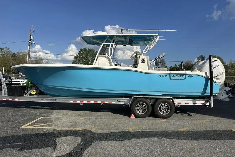 Slide: The Image of 2024 Key West 291 FS boat interior with plush seating and modern steering wheel. - 7