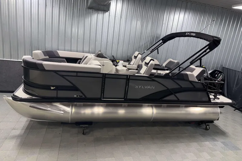 The Image of 2026 Sylvan L1 LZ pontoon boat in showroom, featuring sleek design and modern seating. - 1