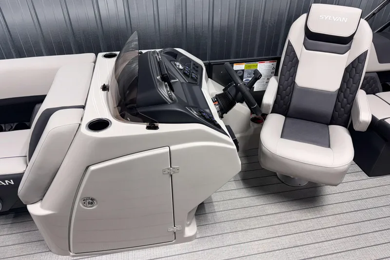 Slide: The Image of 2026 Sylvan L1 LZ boat interior with steering console and captain's chair. - 11
