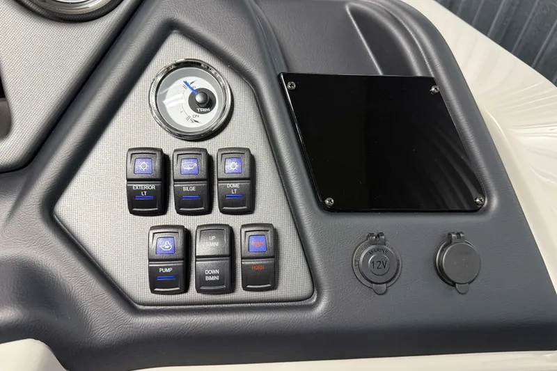 Slide: The Image of Control panel of 2026 Sylvan L1 LZ boat with switches and 12V outlets. - 17