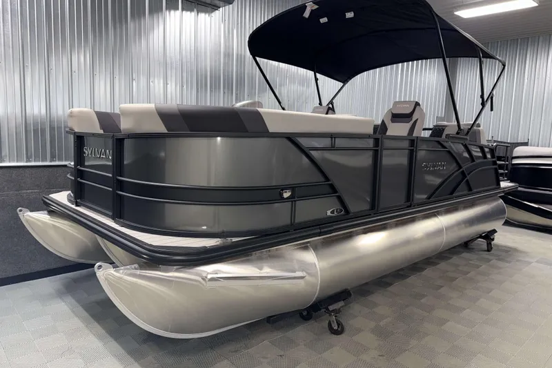 Slide: The Image of 2026 Sylvan L1 LZ pontoon boat with sleek design in a showroom setting. - 24