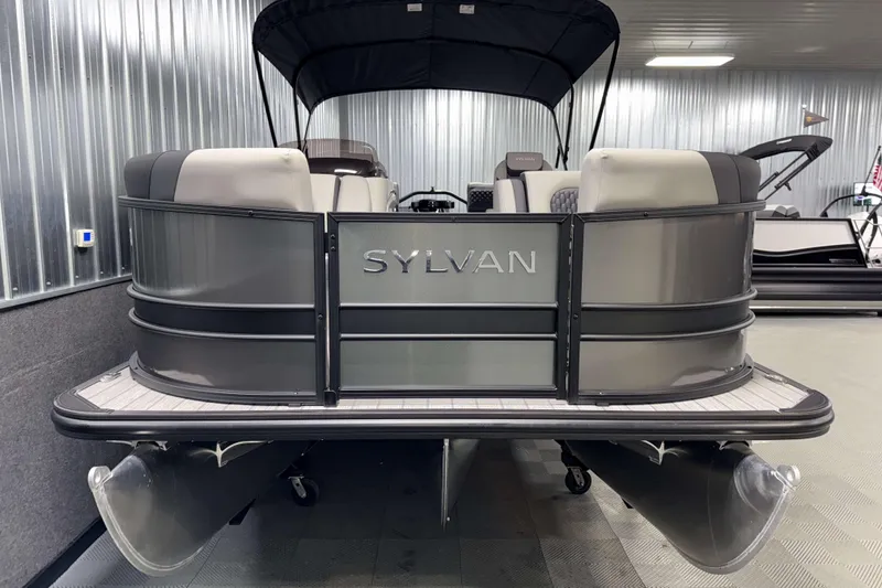 Slide: The Image of 2026 Sylvan L1 LZ pontoon boat in a showroom, featuring sleek design and comfortable seating. - 25