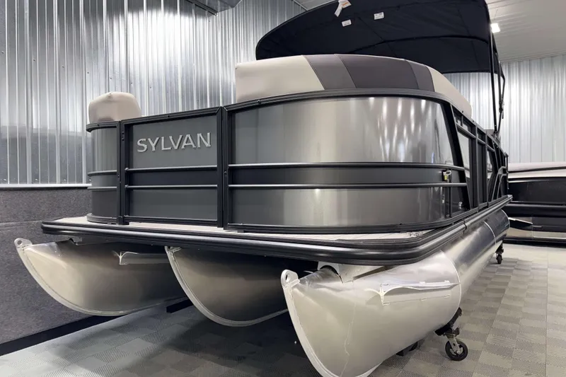 Slide: The Image of 2026 Sylvan L1 LZ pontoon boat in showroom, featuring sleek design and modern finish. - 26
