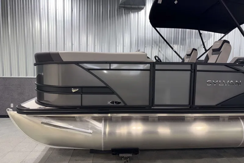 Slide: The Image of 2026 Sylvan L1 LZ pontoon boat with sleek design and modern seating in a showroom. - 27