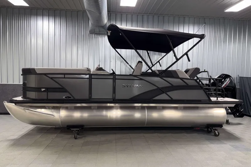 Slide: The Image of 2026 Sylvan L1 LZ pontoon boat in a showroom with canopy and modern design. - 28