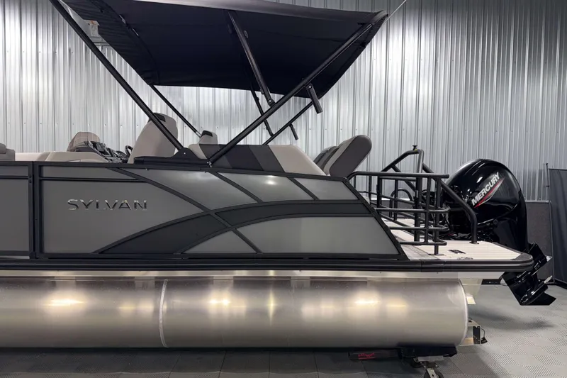 Slide: The Image of 2026 Sylvan L1 LZ pontoon boat with Mercury outboard motor in a showroom. - 29