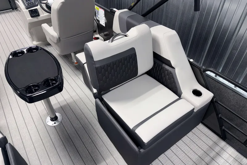 Slide: The Image of 2026 Sylvan L1 LZ boat interior with gray seating and black table. - 5