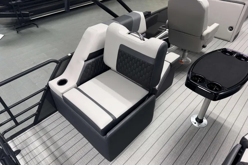 Slide: The Image of 2026 Sylvan L1 LZ boat interior with gray seating and black table. - 8