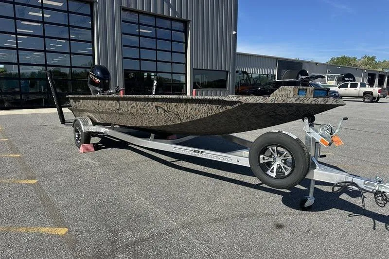 The Image of 2026 Xpress H18DB boat on trailer outside dealership, showcasing sleek design and modern features. - 0