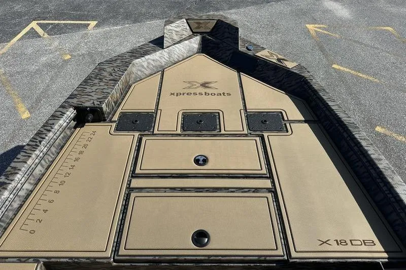 Slide: The Image of 2026 Xpress H18DB boat deck with storage compartments and measuring ruler. - 2
