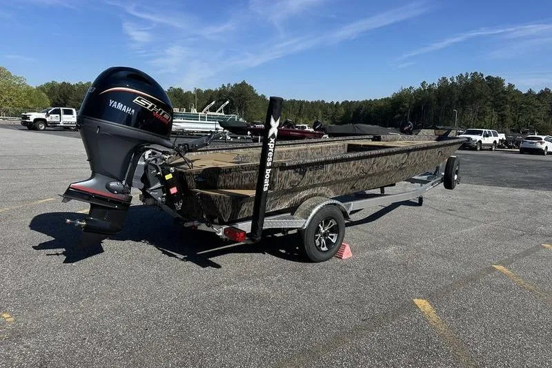 Slide: The Image of 2026 Xpress H18DB boat on trailer with Yamaha motor in parking lot. - 4