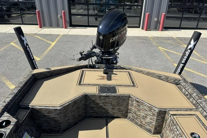 Slide: The Image of 2026 Xpress H18DB boat with camo design and powerful outboard motor. - 7