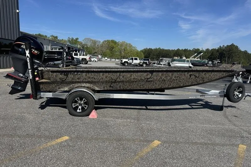 Slide: The Image of 2026 Xpress H18DB boat on trailer in parking lot, sunny day. - 8