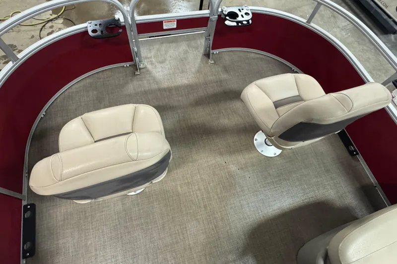 Slide: The Image of 2024 Sun Tracker Bass Buggy 16 XL Select interior with beige seats and red trim. - 13
