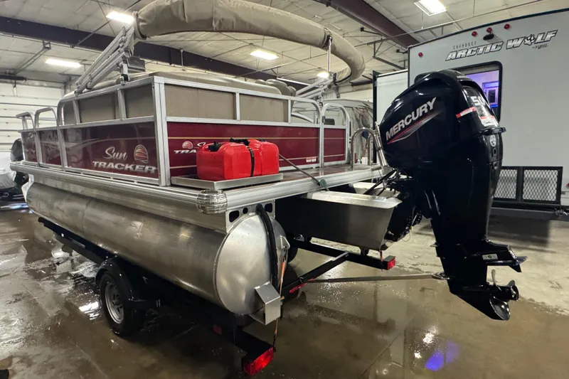 Slide: The Image of 2024 Sun Tracker Bass Buggy 16 XL Select pontoon boat with Mercury outboard motor in a garage. - 3