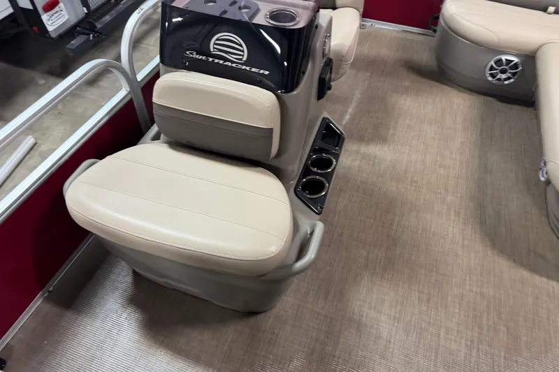 Slide: The Image of 2024 Sun Tracker Bass Buggy 16 XL Select interior with beige seating and cup holders. - 6