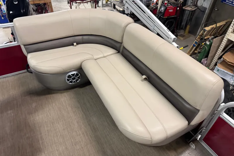 Slide: The Image of 2024 Sun Tracker Bass Buggy 16 XL Select pontoon boat seating, beige and brown upholstery. - 7