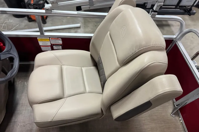 Slide: The Image of 2024 Sun Tracker Bass Buggy 16 XL Select boat seat, beige upholstery, and armrest detail. - 8