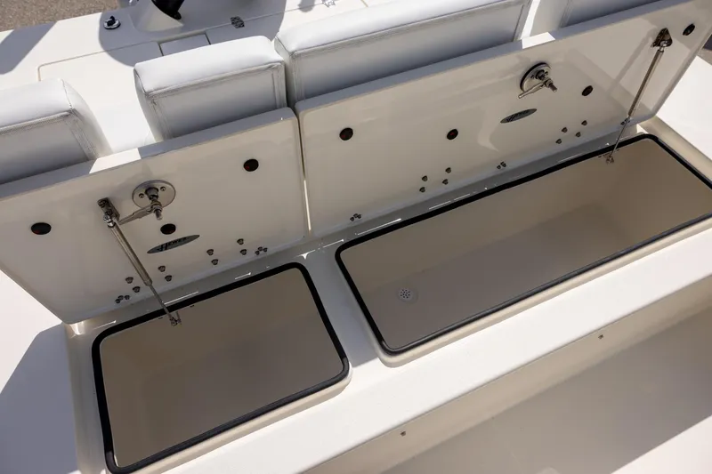 Slide: The Image of 2025 Hewes Redfisher 21 boat storage compartments open, showcasing interior space. - 12