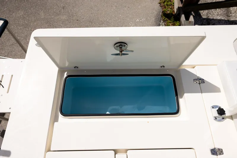 Slide: The Image of Open storage compartment on 2025 Hewes Redfisher 21 boat, showcasing interior design. - 14