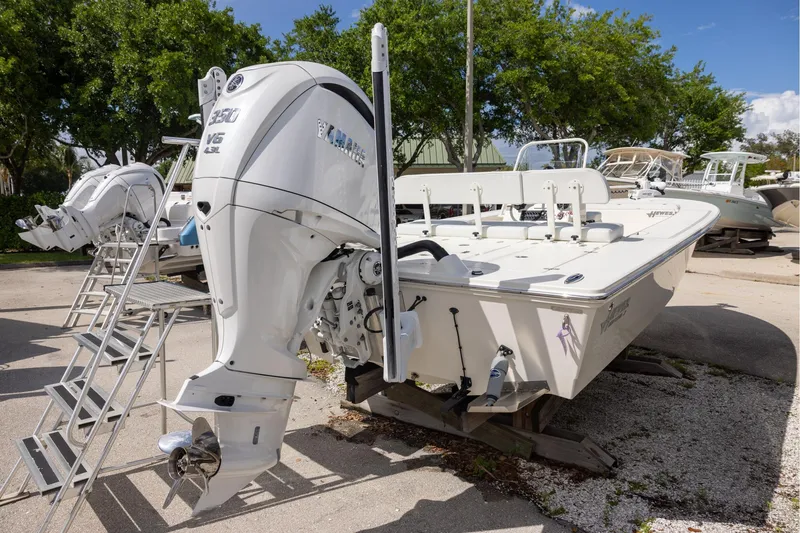 Slide: The Image of 2025 Hewes Redfisher 21 boat with Yamaha V6 engine, parked outdoors. - 3