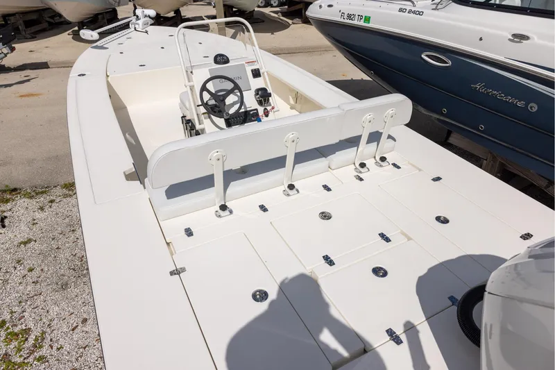 Slide: The Image of 2025 Hewes Redfisher 21 boat interior with steering console and storage compartments. - 4