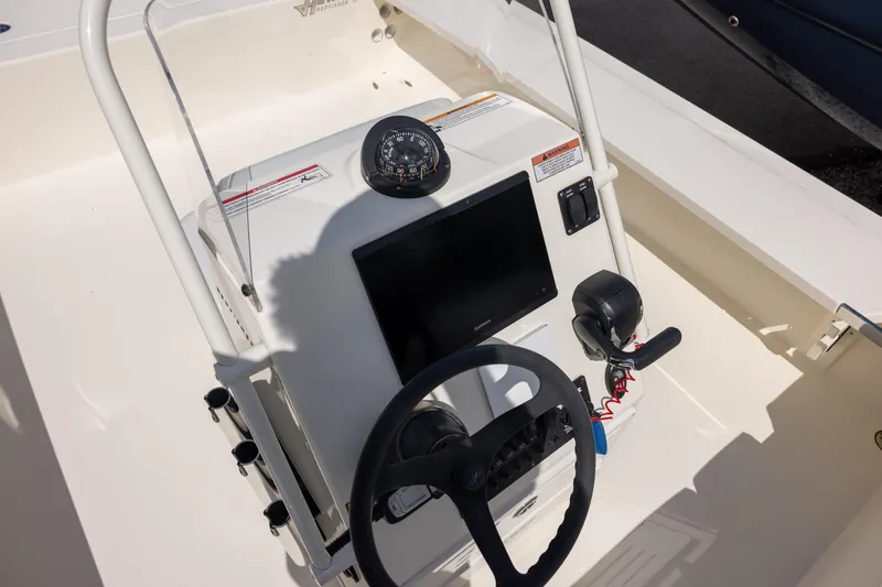 Slide: The Image of 2025 Hewes Redfisher 21 boat console with steering wheel and navigation equipment. - 7