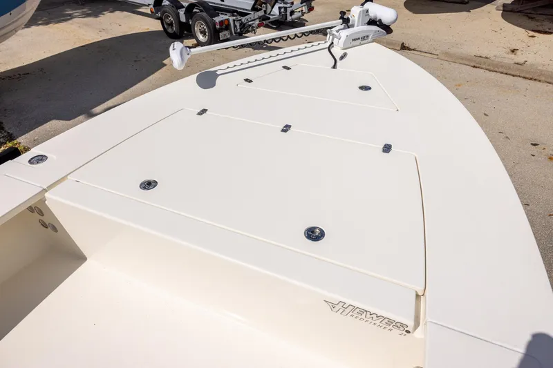Slide: The Image of 2025 Hewes Redfisher 21 boat deck with storage compartments and trolling motor. - 8