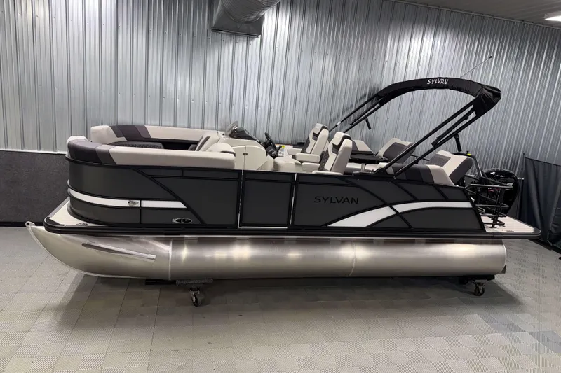 The Image of 2026 Sylvan L1 LZ pontoon boat in showroom, featuring sleek design and modern seating. - 1