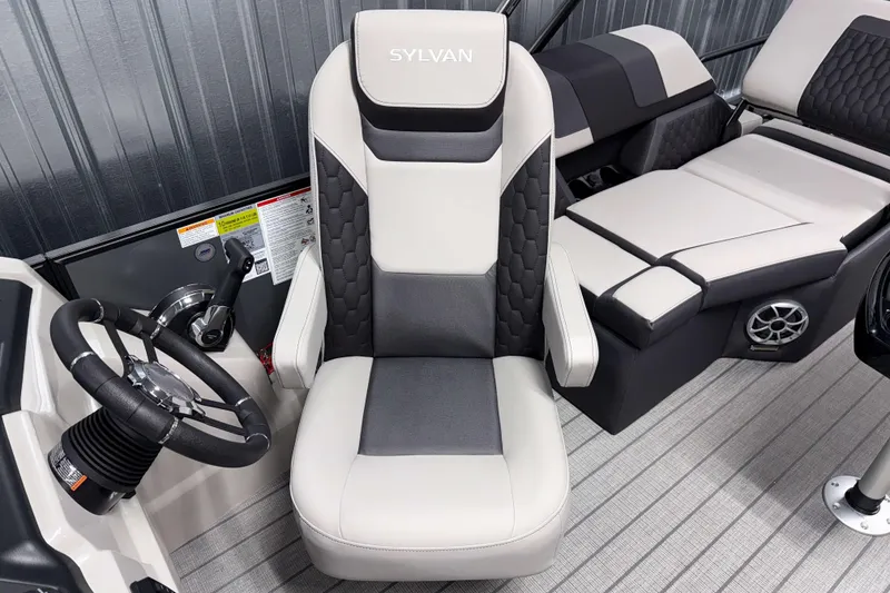 Slide: The Image of 2026 Sylvan L1 LZ boat interior with steering wheel and cushioned seating. - 12