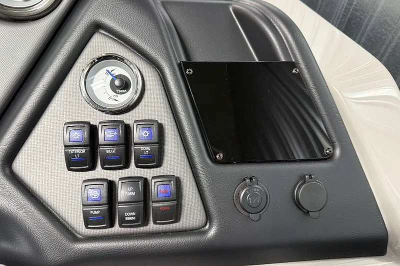 Slide: The Image of Control panel of 2026 Sylvan L1 LZ boat with switches and trim gauge. - 17