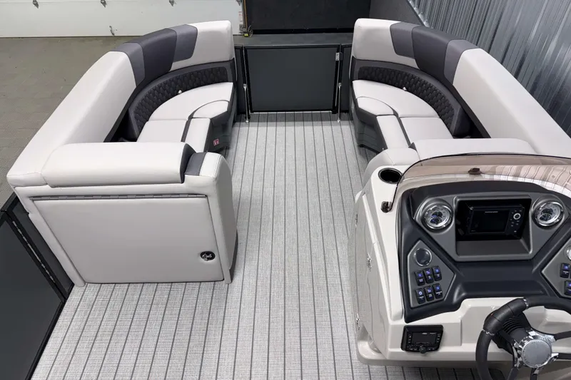 Slide: The Image of Luxurious interior of 2026 Sylvan L1 LZ pontoon boat with plush seating and modern dashboard. - 19