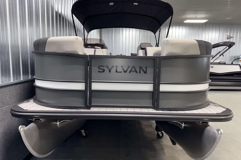 Slide: The Image of 2026 Sylvan L1 LZ pontoon boat in showroom, featuring sleek design and modern seating. - 25