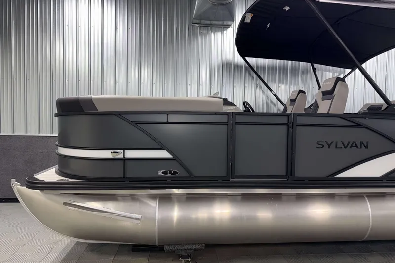 Slide: The Image of 2026 Sylvan L1 LZ pontoon boat with sleek design in a metallic indoor setting. - 26