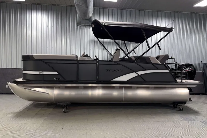 Slide: The Image of 2026 Sylvan L1 LZ pontoon boat with canopy in a showroom setting. - 27