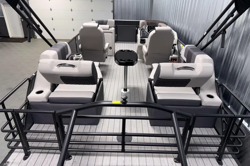 Slide: The Image of 2026 Sylvan L1 LZ pontoon boat interior with modern seating and steering console. - 3
