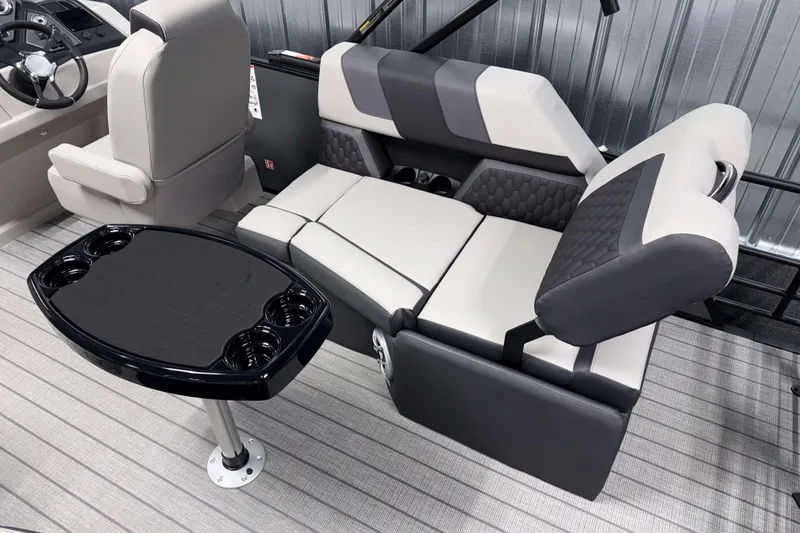 Slide: The Image of Luxurious interior of 2026 Sylvan L1 LZ boat with plush seating and cupholder table. - 4